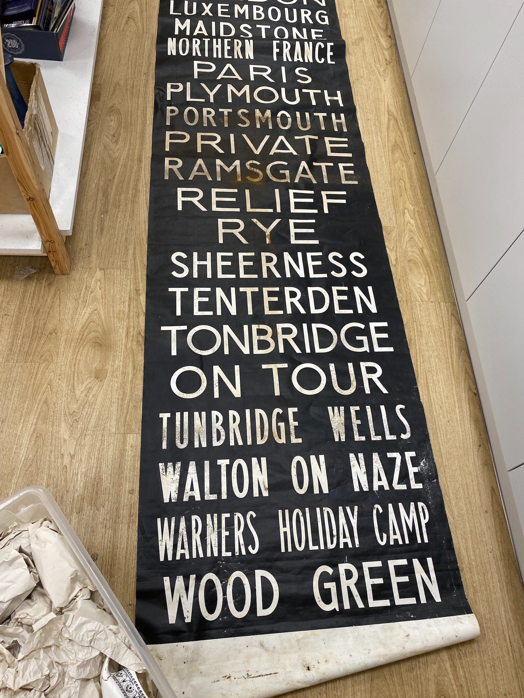 A painted canvas alphabetical list of European destinations including Sussex areas such as Brighton approximately 695x80cm